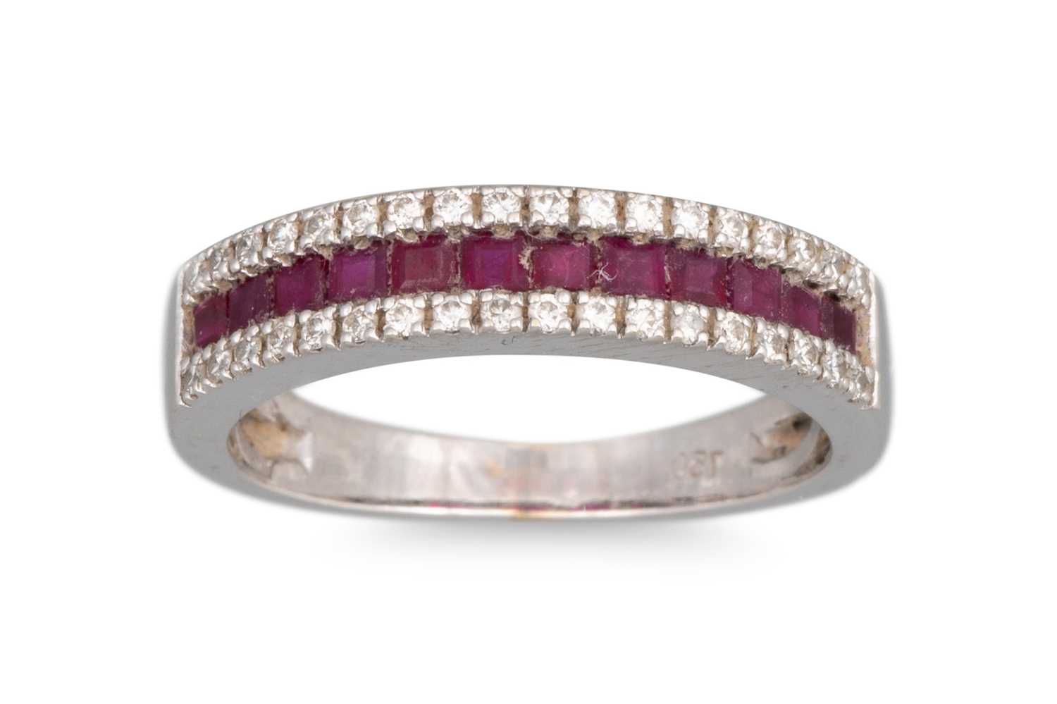 Lot 303 - A RUBY AND DIAMOND BAND RING, the channel set...