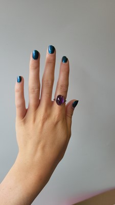 Lot 72 - A CABOCHON TANZANITE AND DIAMOND CLUSTER RING,...