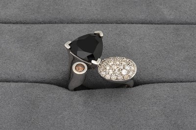 Lot 61 - A DIAMOND AND ONYX RING, of crossover form,...