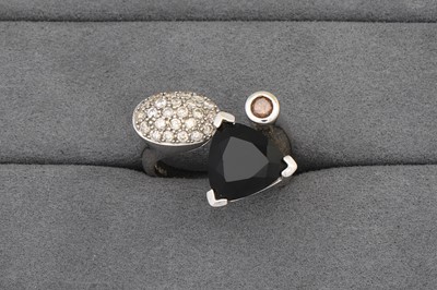 Lot 61 - A DIAMOND AND ONYX RING, of crossover form,...