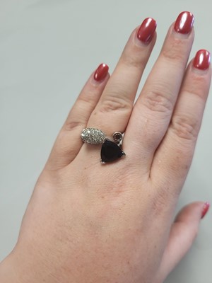 Lot 61 - A DIAMOND AND ONYX RING, of crossover form,...