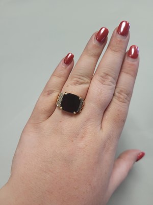 Lot 62 - AN ONYX RING, to diamond shoulders, mounted in...