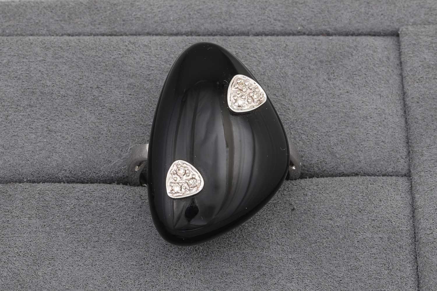 Lot 64 - AN ONYX PLAQUE RING, diamond detail, mounted...