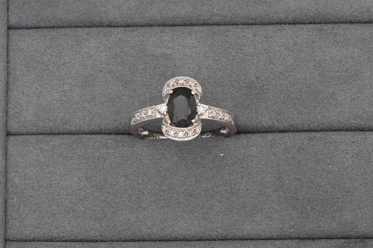 Lot 68 - A SAPPHIRE AND DIAMOND CLUSTER RING, mounted...