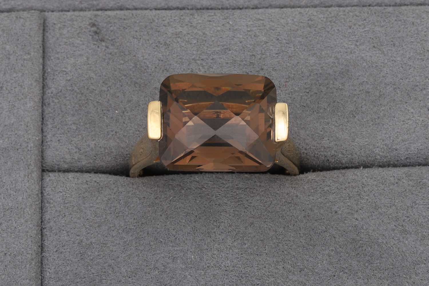 Lot 69 - A SMOKEY QUARTZ RING, mounted in 9ct yellow...