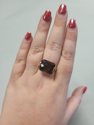 Lot 69 - A SMOKEY QUARTZ RING, mounted in 9ct yellow...