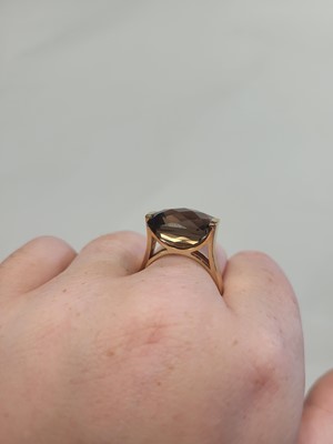 Lot 69 - A SMOKEY QUARTZ RING, mounted in 9ct yellow...