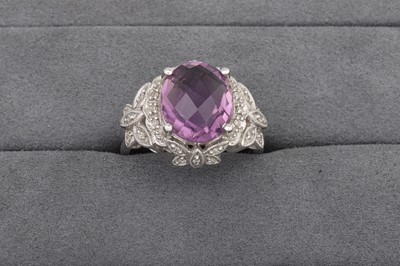 Lot 78 - AN AMETHYST RING, to diamond surround and...