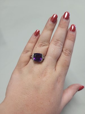 Lot 80 - A CUSHION-SHAPED AMETHYST RING, to diamond...