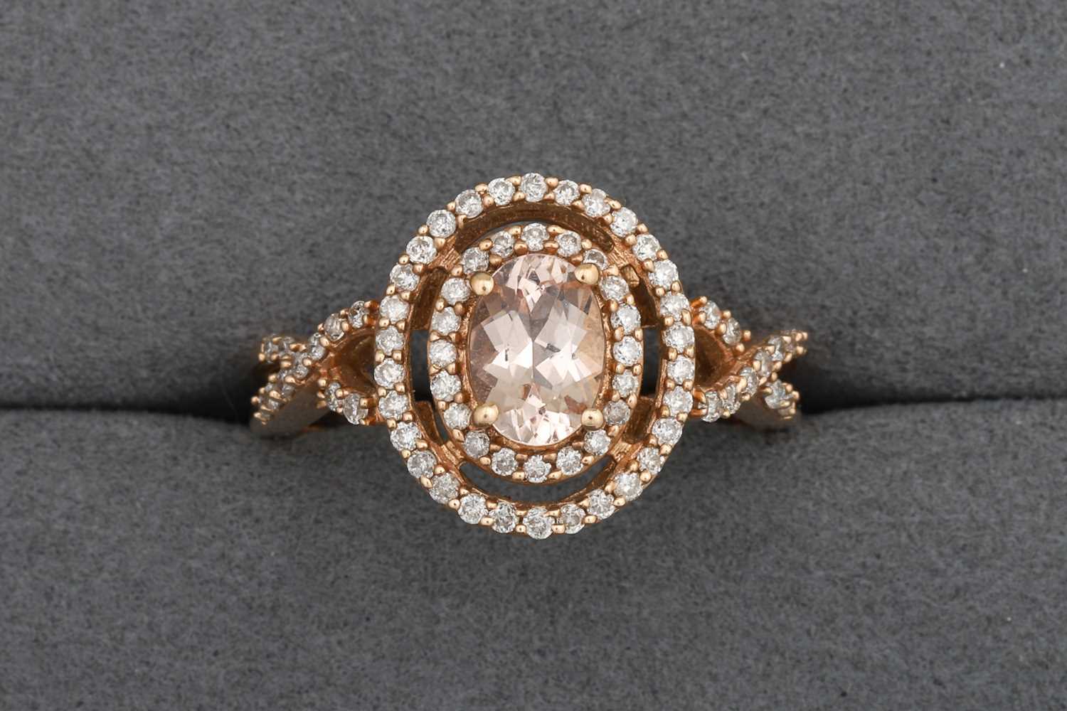 Lot 84 - A MORGANITE AND DIAMOND HALO CLUSTER RING,...