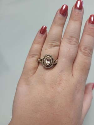 Lot 84 - A MORGANITE AND DIAMOND HALO CLUSTER RING,...