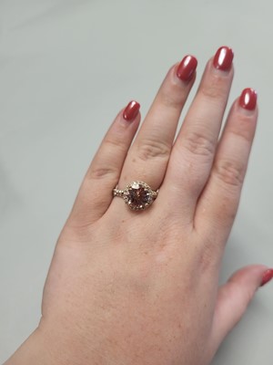 Lot 86 - A MORGANITE AND DIAMOND CLUSTER RING, to split...