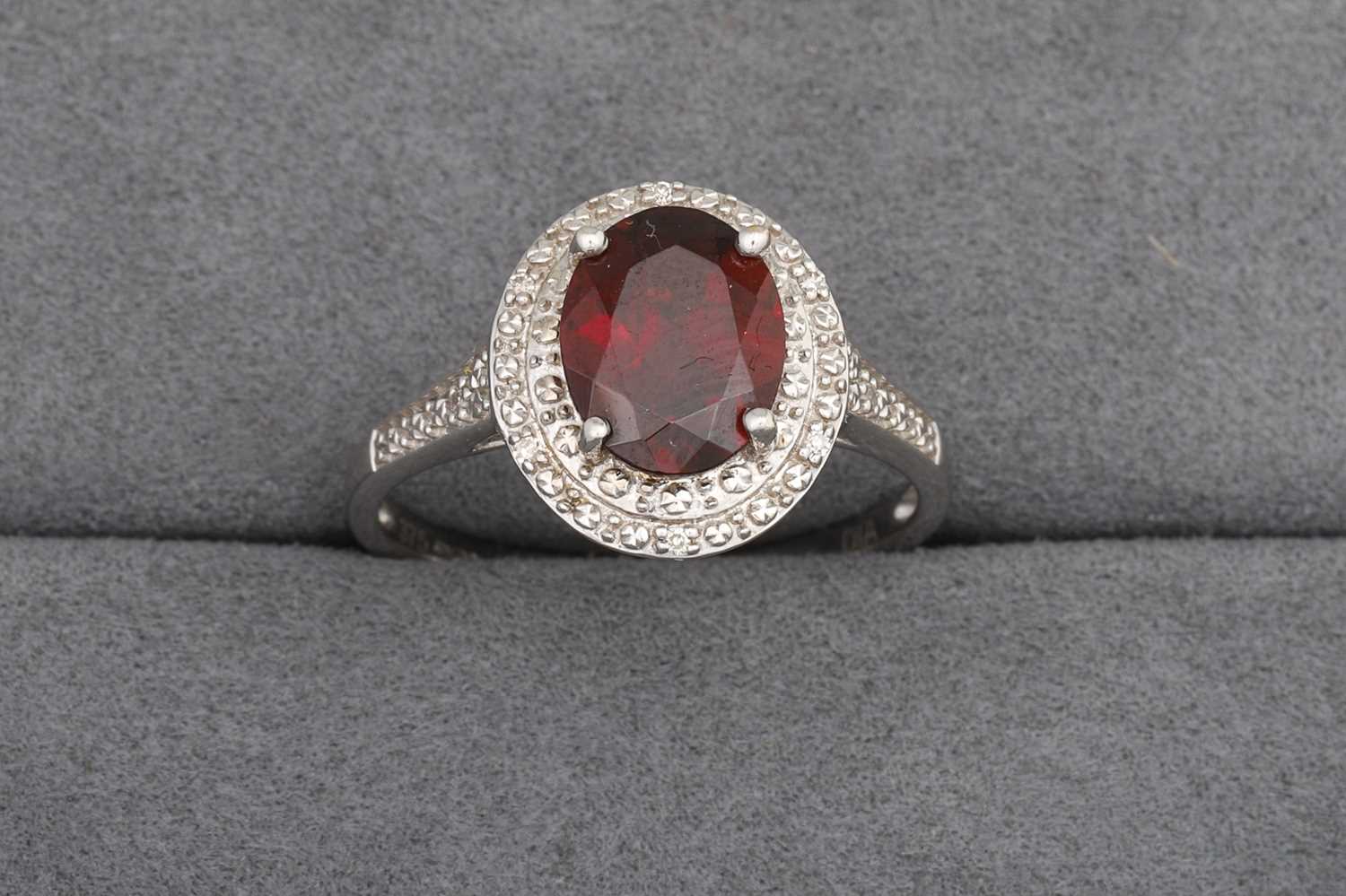 Lot 93 - A GARNET AND DIAMOND CLUSTER RING, mounted in...