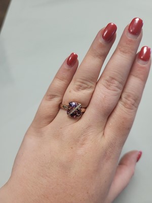 Lot 94 - AN AMETHYST AND DIAMOND CLUSTER RING, mounted...