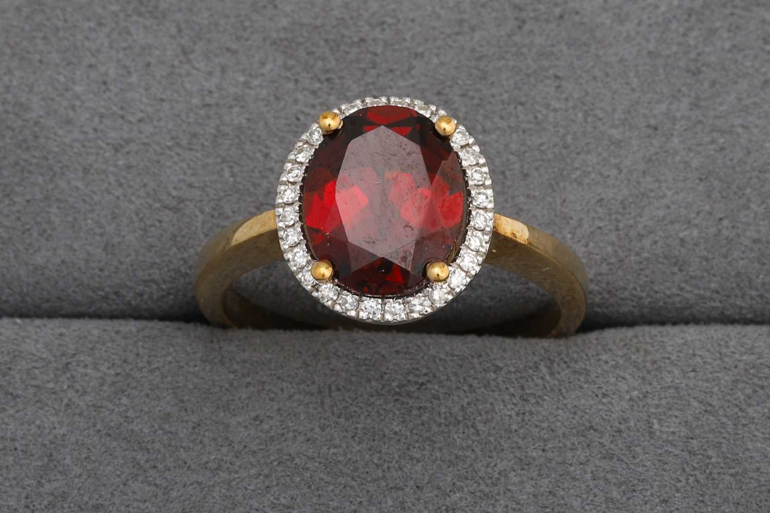 Lot 95 - A GARNET AND DIAMOND CLUSTER RING, mounted in...