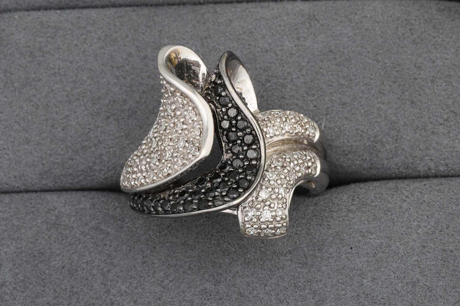 Lot 97 - A DIAMOND CLUSTER RING, pavé set in 14ct white...