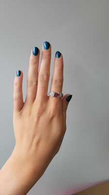 Lot 8 - A RUBY AND DIAMOND RING, the oval ruby to pavé...