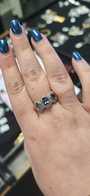 Lot 19 - A THREE STONE CLUSTER RING, set with...