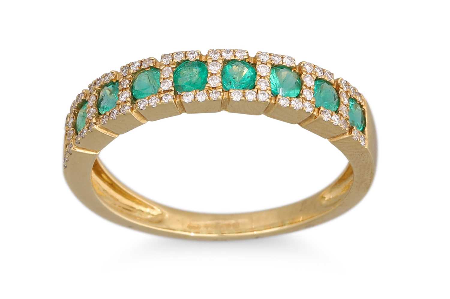 Lot 28 - AN EMERALD AND DIAMOND ETERNITY RING, the...