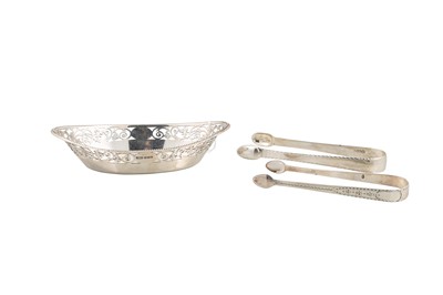 Lot 503 - TWO GEORGIAN SILVER TONGS, with bright cut...
