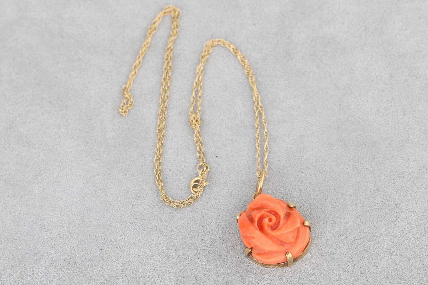 Lot 18 - A CORAL PENDANT, modelled as a rose, in a 9ct...