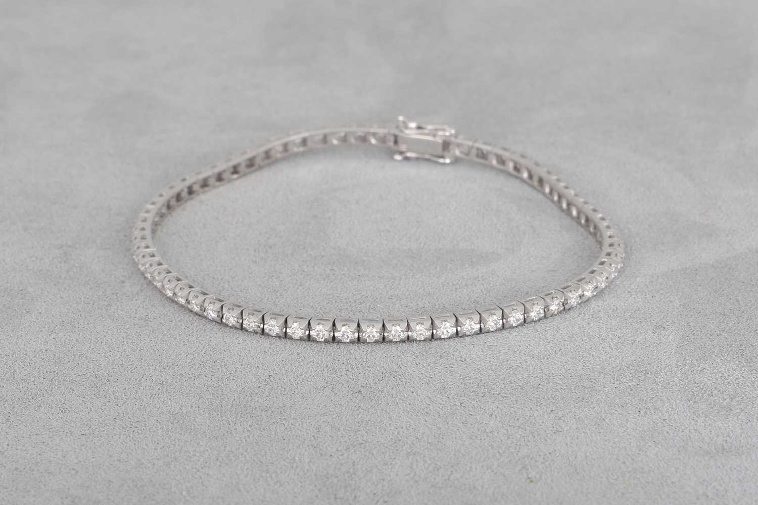 A DIAMOND LINE BRACELET, mounted in 18ct white...