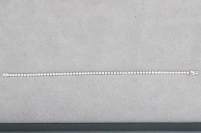 A DIAMOND LINE BRACELET, mounted in 18ct white...