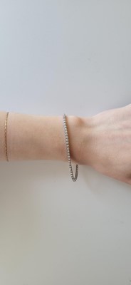 A DIAMOND LINE BRACELET, mounted in 18ct white...