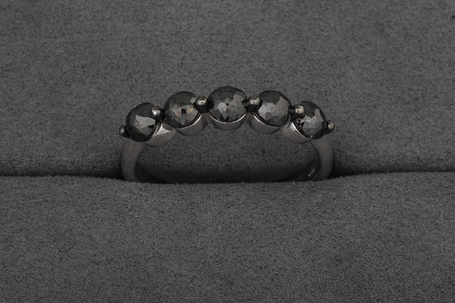 A BLACK DIAMOND FIVE STONE RING, mounted in...