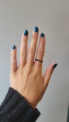 A BLACK DIAMOND FIVE STONE RING, mounted in...