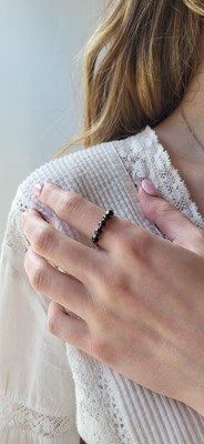 A BLACK DIAMOND FIVE STONE RING, mounted in...