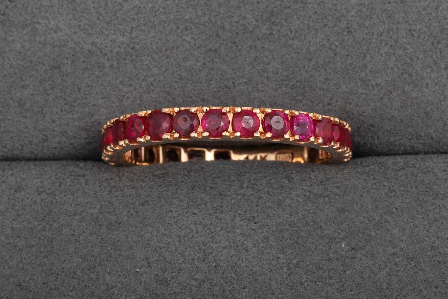 Lot 86 - A RUBY FULL ETERNITY RING, mounted in 14ct...