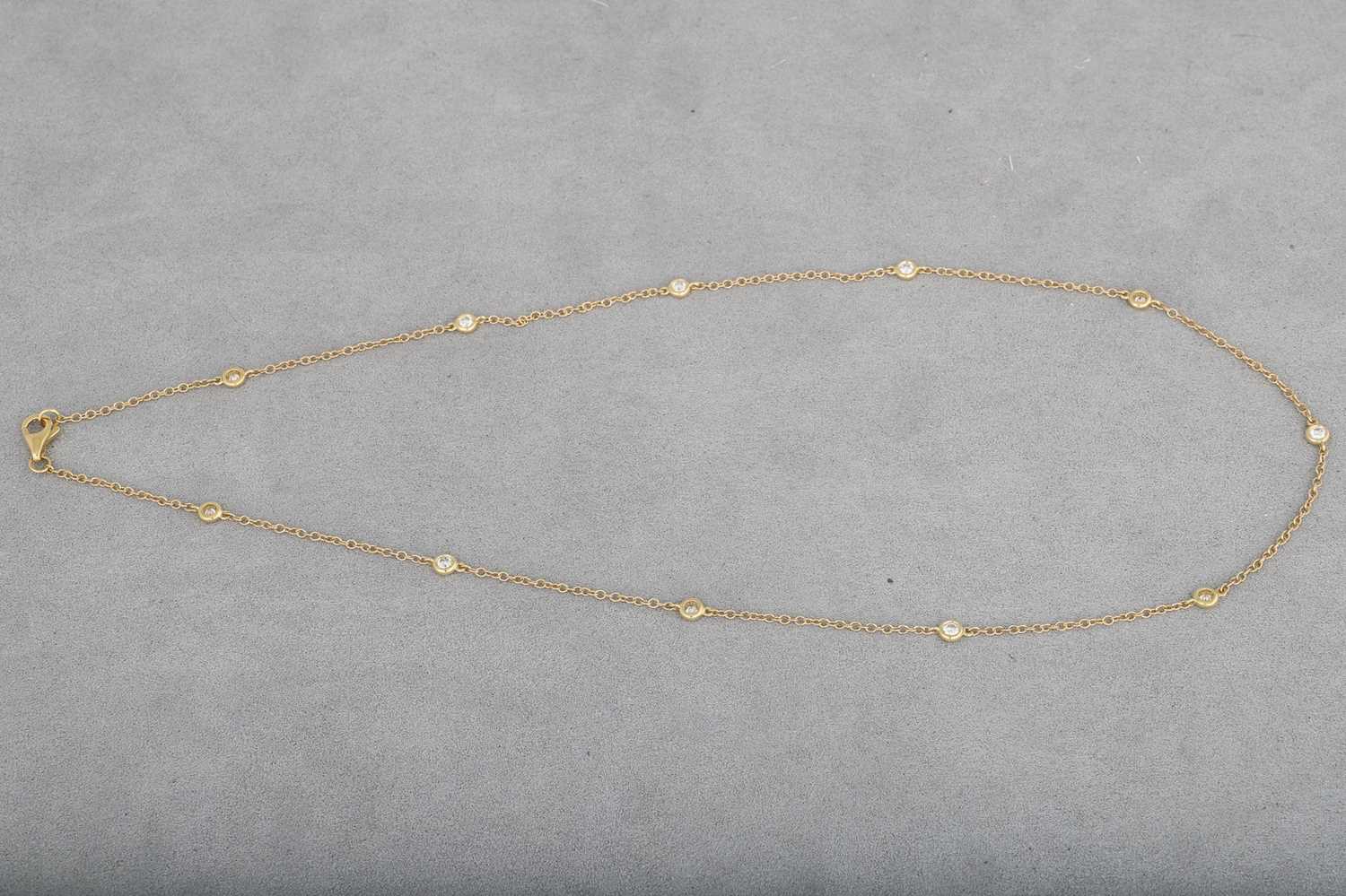 A DIAMOND SET CHAIN NECKLACE, the collet set...