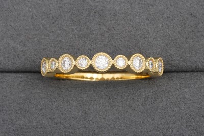A DIAMOND HALF ETERNITY RING, collet set...