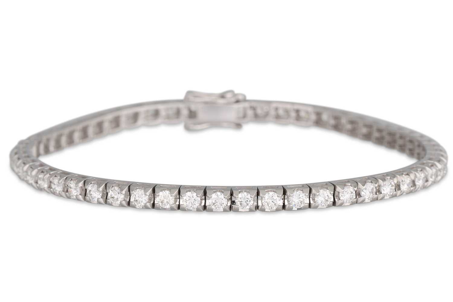 Lot 277 - A DIAMOND LINE BRACELET, mounted in 18ct white...