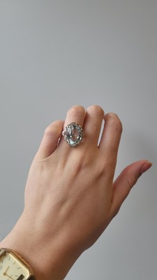 Lot 51 - AN AQUAMARINE AND DIAMOND SET DRESS RING,...