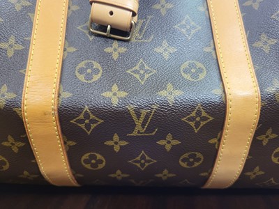 Lot 416 - A LOUIS VUITTON "KEEP ALL TRAVEL BAG" coated...