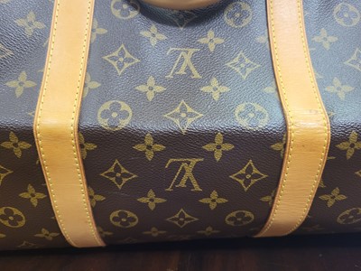 Lot 416 - A LOUIS VUITTON "KEEP ALL TRAVEL BAG" coated...
