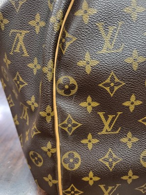 Lot 416 - A LOUIS VUITTON "KEEP ALL TRAVEL BAG" coated...