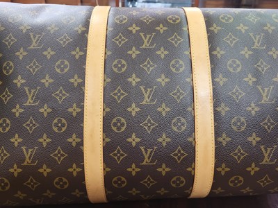 Lot 416 - A LOUIS VUITTON "KEEP ALL TRAVEL BAG" coated...