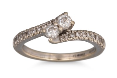 Lot 397 - A TWO STONE DIAMOND RING, of cross-over design,...