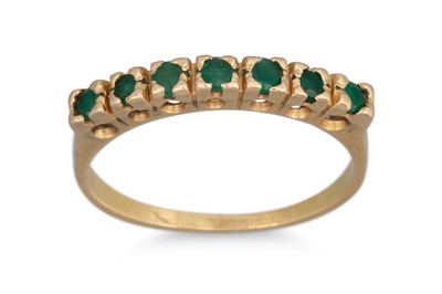 Lot 133 - A SEVEN STONE EMERALD RING, mounted in 18ct...