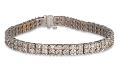 Lot 315 - A TWO ROWED DIAMOND LINE BRACELET, the round...