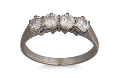 Lot 317 - A FOUR STONE DIAMOND RING, the brilliant cut...