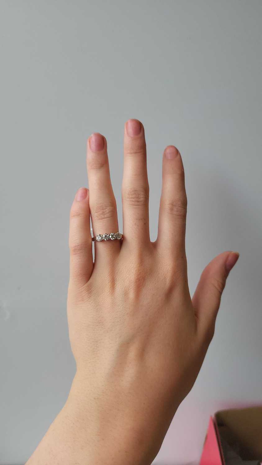 Lot 92 - A FOUR STONE DIAMOND RING, the brilliant cut...