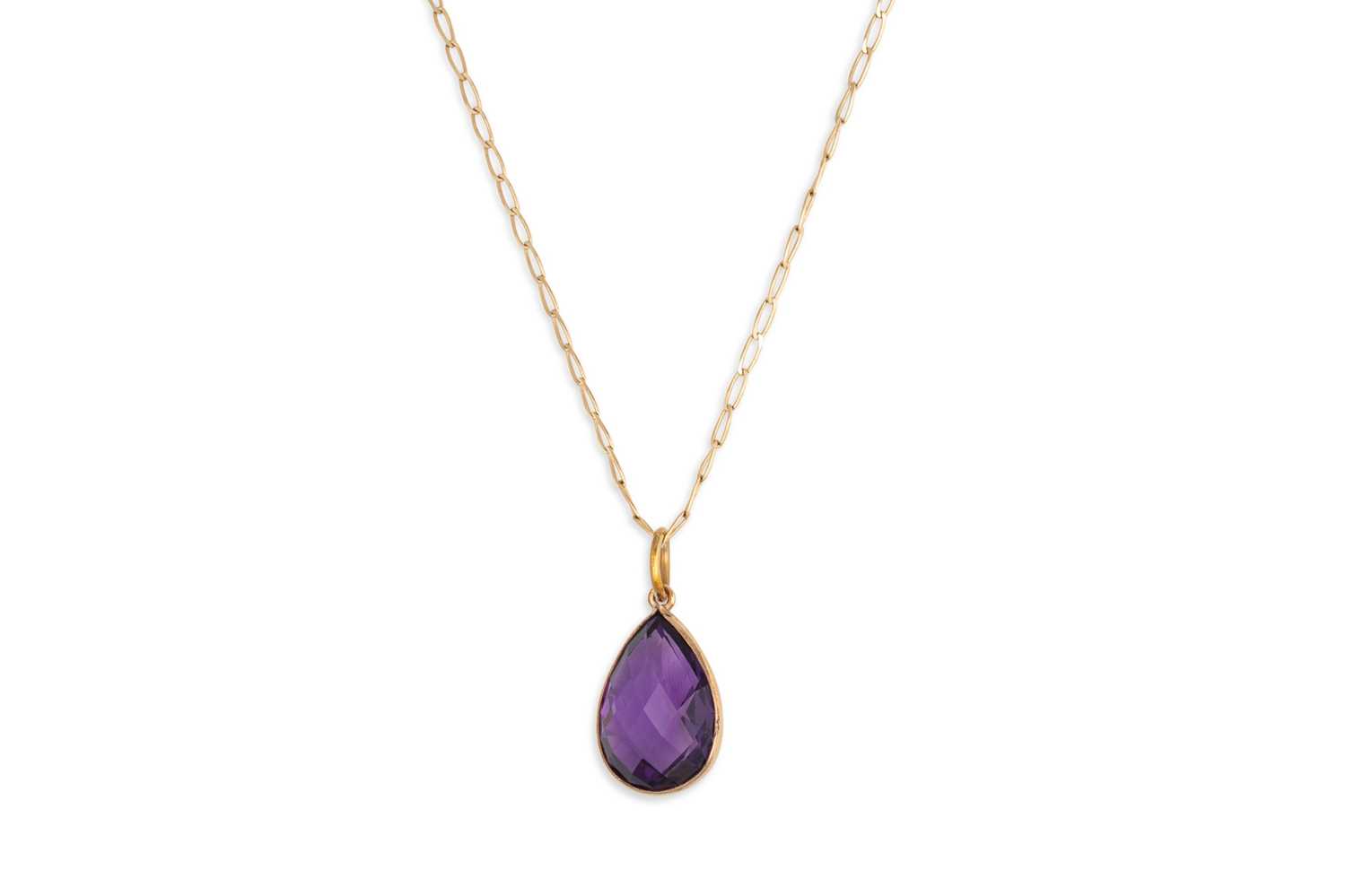 Lot 21 - AN AMETHYST PENDANT, the bezel set mixed cut...