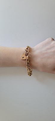 Lot 23 - A 9CT GOLD CURB LINK BRACELET, with padlock...