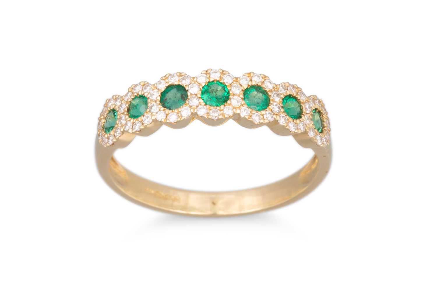 Lot 70 - A DIAMOND AND EMERALD RING, the round emeralds...