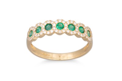 Lot 70 - A DIAMOND AND EMERALD RING, the round emeralds...