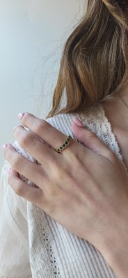 Lot 70 - A DIAMOND AND EMERALD RING, the round emeralds...